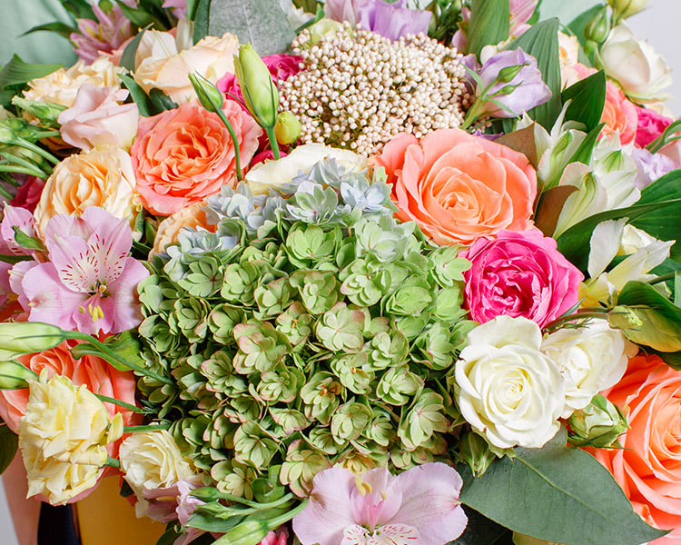 A colorful bouquet of orange and pink hydrangea in a large bouquet